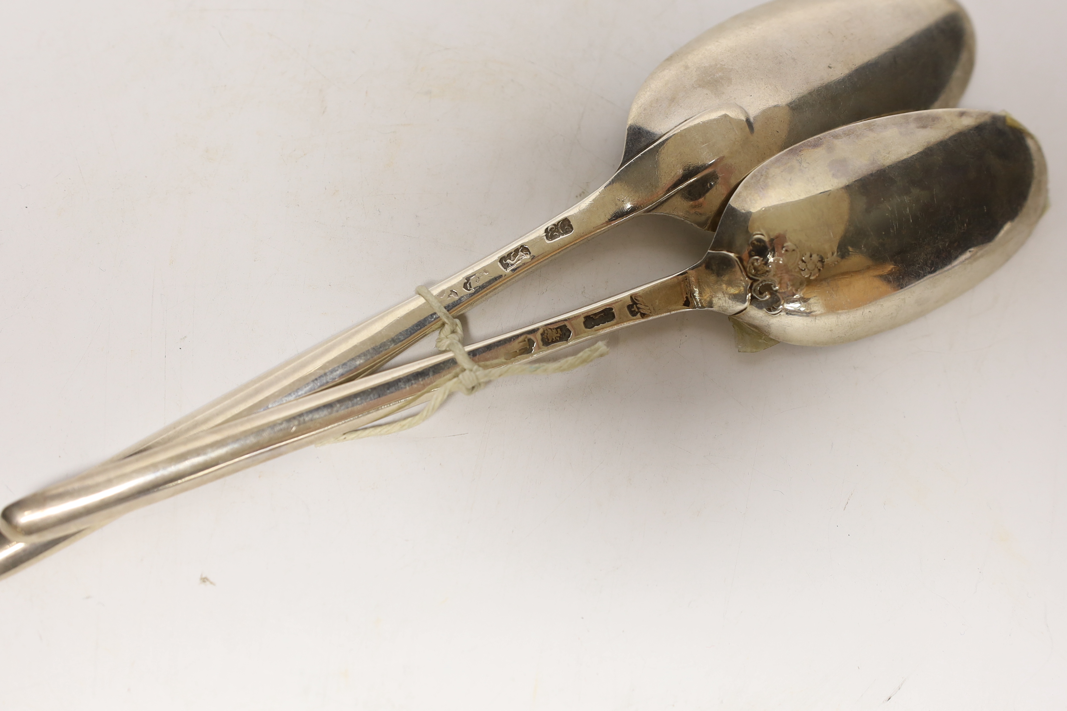 Two 18th century silver combination marrow scoop spoons, smallest with lace back bowl, Marmaduke Daintrey, London, 1741, the other later by Ebeneezer Coker, 21.5cm, 99 grams.